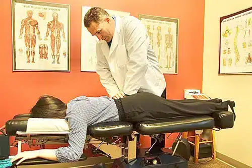 Chiropractor performing spinal adjustment on a patient at Vital Mill Creek Chiropractic